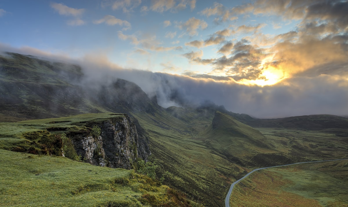Green pastures and still valleys under a breaking sky