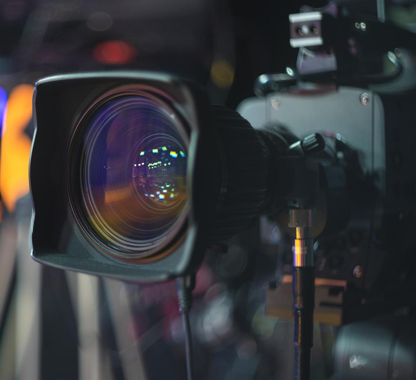 Studio video camera lens facing stage lights