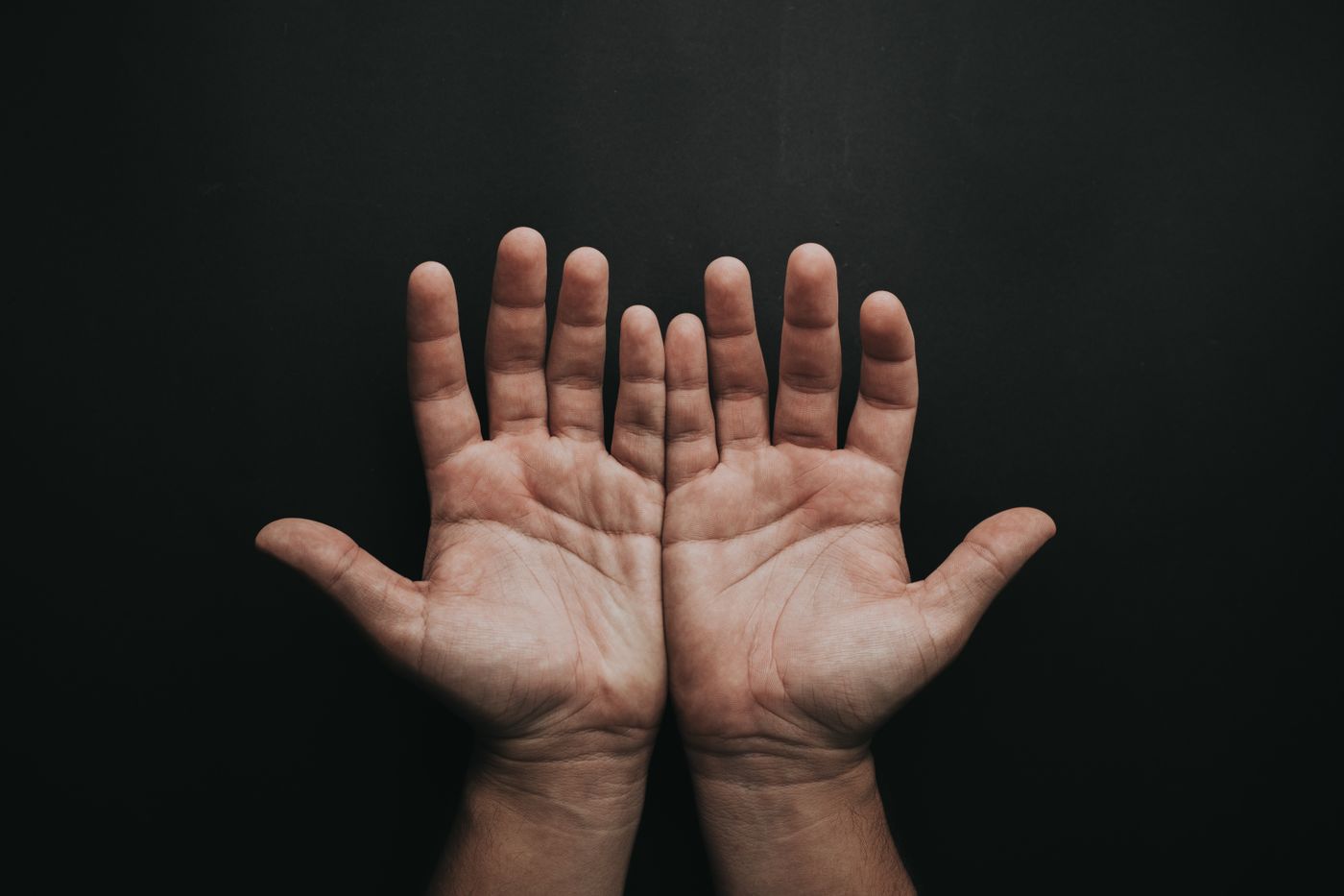 Open, cupped hands raised in prayer