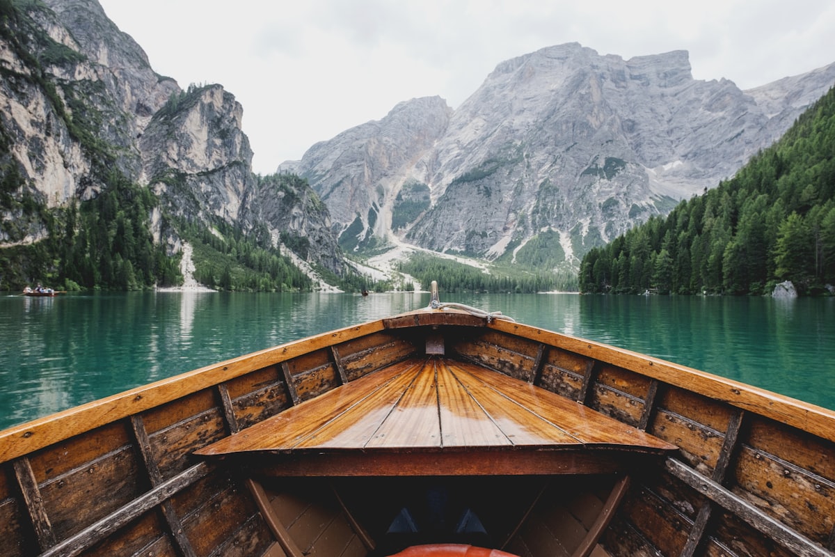 The prow of a wooden boat on open water